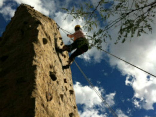 The Relaxed Traveler climbing a rock wall, not so relaxed